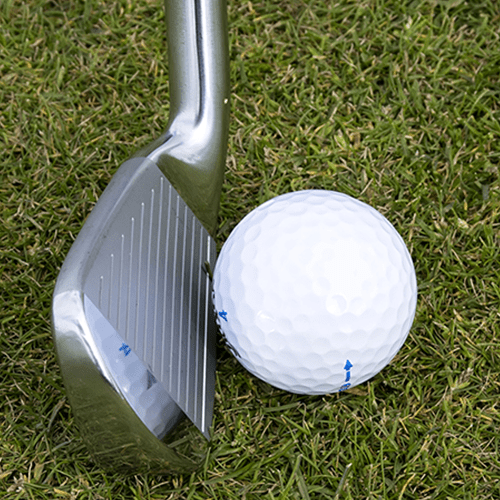 golf ball near club