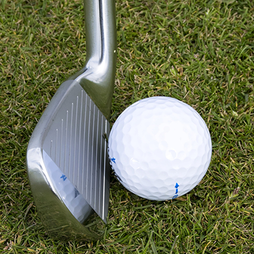 golf ball near club